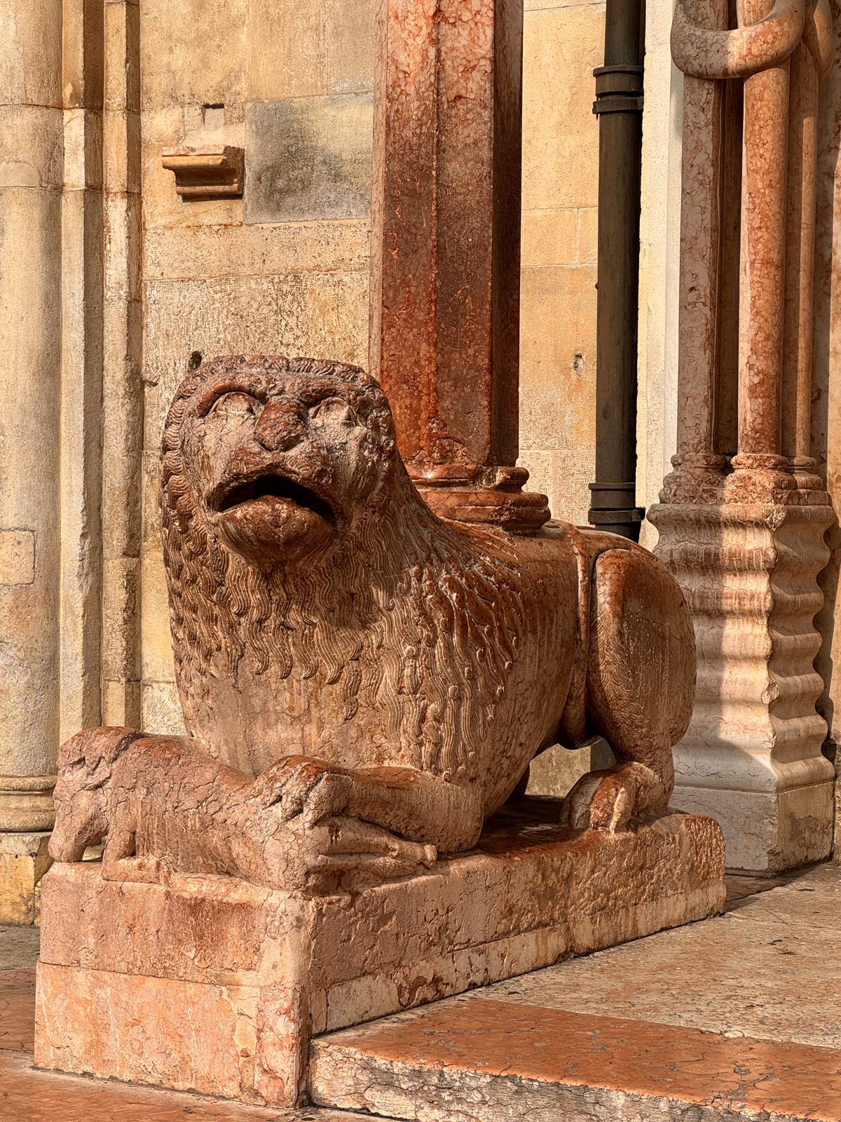 A crouching lion supporting a porch column