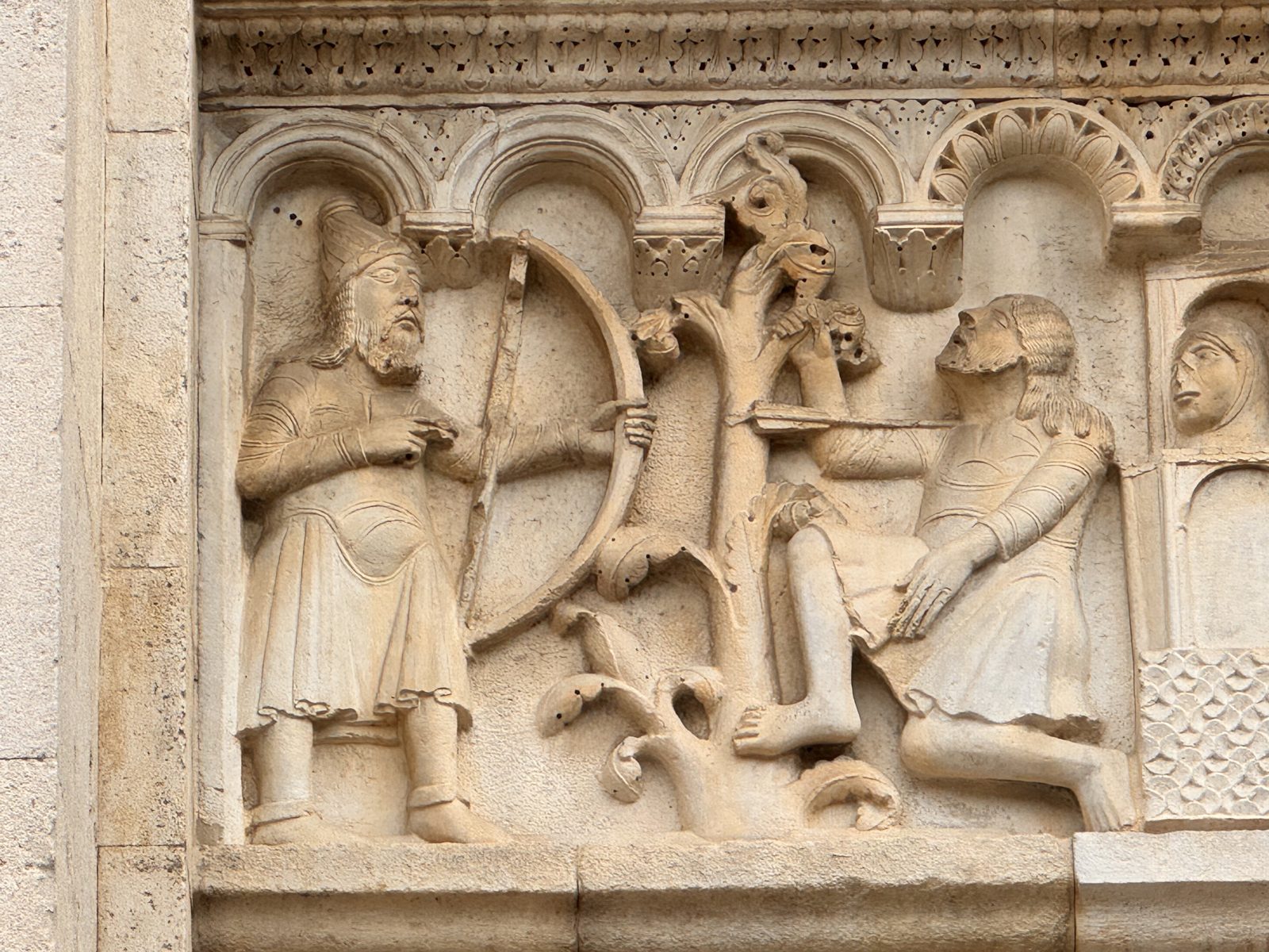 One of Wiligelmo’s Genesis reliefs: blind Lamech, guided by a young man, draws his bow and kills Cain, hidden in the bushes