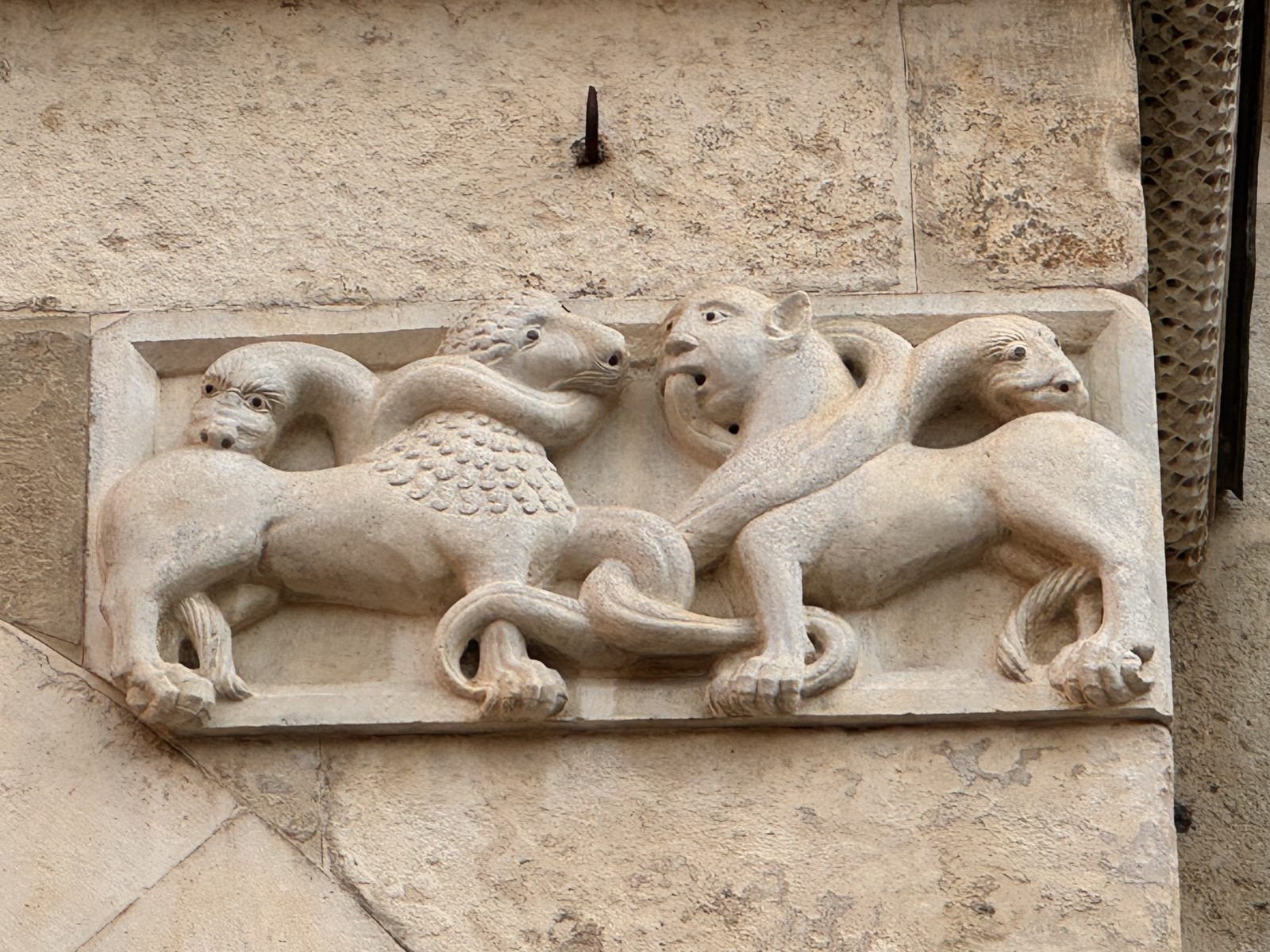 Two lions with intertwined bodies bite one another: the endless struggle of the forces of evil, or the conflict of the passions within the soul