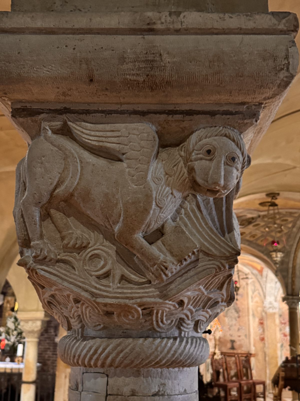 A winged lion, possibly the symbol of Saint Mark, turning its head back over its wing