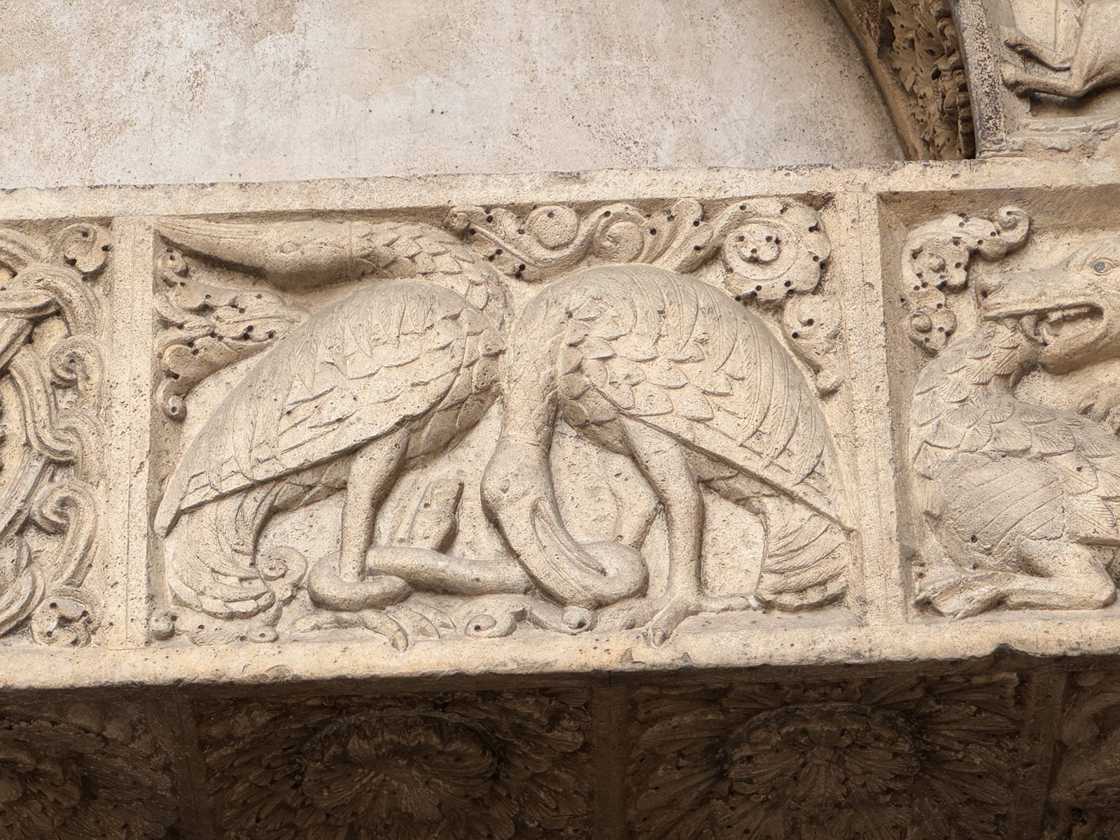 Two long-necked birds face each other among foliage, a motif of harmony that balances the struggles shown in the neighbouring panels